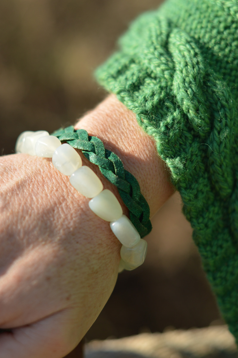 Green poncho and green bracelets